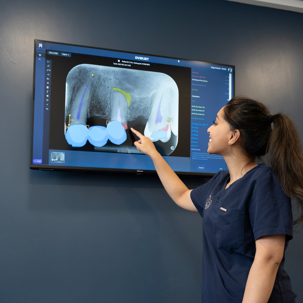 Patient with a broken molar discussing treatment options with a dentist at Regent Dental